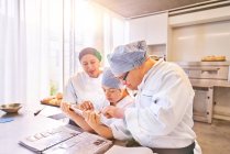 Chef and students with Down Syndrome using digital tablet in kitchen — Stock Photo