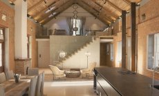 Home showcase interior with vaulted ceiling and loft — Stock Photo