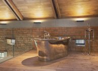 Home showcase interior stainless steel bathtub in loft bathroom — Stock Photo