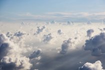 Aerial view fluffy white clouds in sunny, ethereal sky — Stock Photo