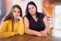 Portrait confident beautiful mother and daughter — Stock Photo