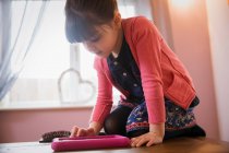 Curious girl using digital tablet — Stock Photo