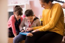 Brother and sisters using digital tablet — Stock Photo