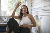 Portrait happy carefree young woman in home office — Stock Photo