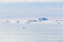 Melting icebergs on vast tranquil Atlantic Ocean Greenland — Stock Photo