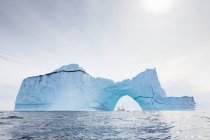 Majestic iceberg arch on sunny blue Atlantic Ocean Greenland — Stock Photo