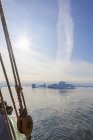 View of icebergs from sailboat on sunny Atlantic Ocean Greenland — Stock Photo