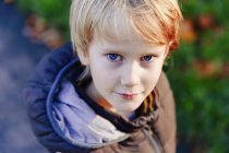 Portrait confident boy with blond hair and blue eyes — Stock Photo