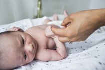 Close up mother holding hands with newborn baby son — Stock Photo