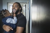 Portrait happy father holding toddler son — Stock Photo
