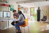 Happy young couple working in home office — Stock Photo