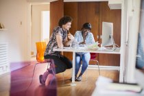 Young creative entrepreneurs working in home office — Stock Photo