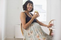 Portrait happy pregnant woman eating avocado toast — Stock Photo