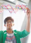Boy student examining DNA model in classroom — Stock Photo