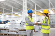 Supervisors handshaking in warehouse — Stock Photo