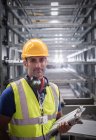 Portrait serious, confident male supervisor with clipboard in steel factory — Stock Photo