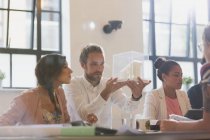Focused architects examining model in conference room meeting — Stock Photo