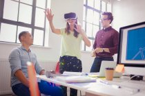 Programadores de computador entusiasmados testando óculos de simulador de realidade virtual no escritório — Fotografia de Stock