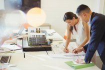 Architects drafting blueprint in conference room — Stock Photo