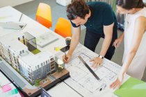 Les architectes rédigent le plan directeur au bureau — Photo de stock