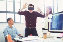 Computer programmers testing virtual reality simulator glasses in office — Stock Photo