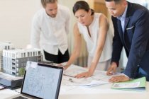 Architects discussing blueprints in meeting — Stock Photo