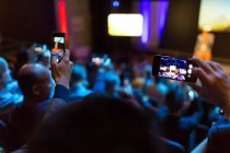 Audience with smart phones videoing conference — Stock Photo