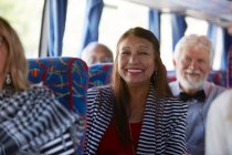 Портрет улыбается, уверенно активная пожилая женщина туристическая поездка автобус — стоковое фото
