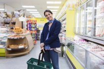 Portrait smiling woman shopping in supermarket — Stock Photo