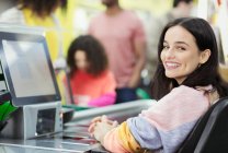 Portrait smiling, confident female cashier working at supermarket checkout — Stock Photo