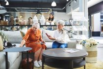 Senior femmes shopping pour canapé dans le magasin de décoration à la maison — Photo de stock
