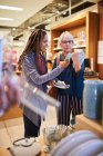 Women with smart phone shopping in home goods store — Stock Photo