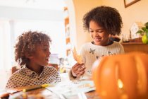 Brother and sister making autumn crafts at table — Stock Photo