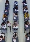 High school teacher supervising students taking exam at desks — Stock Photo