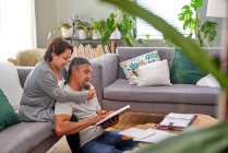 Affectionate couple reading in living room — Stock Photo