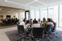 Business people meeting in circle in conference room — Stock Photo
