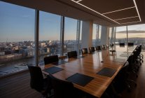Modern highrise conference room table overlooking city — Stock Photo