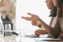 Businesswoman talking and gesturing in conference room meeting — Stock Photo