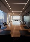 Long wood conference table in empty modern conference room — Stock Photo