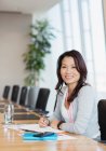 Portrait confident businesswoman working at conference table — Stock Photo