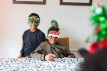 Portrait cute brothers wearing festive Christmas glasses — Stock Photo