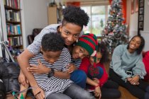 Portrait happy brothers hugging in Christmas living room — Stock Photo