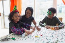 Felice madre e bambini che fanno biscotti di Natale a tavola — Foto stock