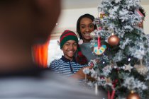 Portrait happy mother and son decorating Christmas tree — Stock Photo