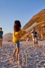 Family playing cricket on summer beach — Stock Photo