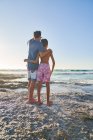 Affectionate father and son on sunny ocean beach — Stock Photo
