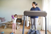 Mother and daughter exercising in living room — Stock Photo