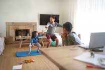 Father and daughter exercising in living room — Stock Photo