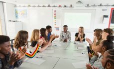 High school students clapping in debate class — Stock Photo