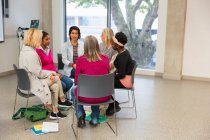 Women's support group talking in circle in community center — Stock Photo